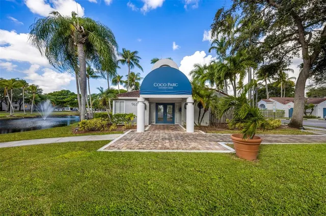 a view of a house with a swimming pool and a yard