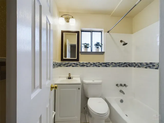 a bathroom with a toilet a sink and a mirror