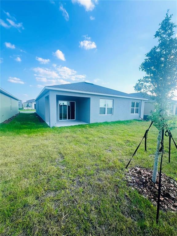 2598 Trinidad Road Haines City, FL 33844 - Photo 17 of 18 a view of a house with a yard