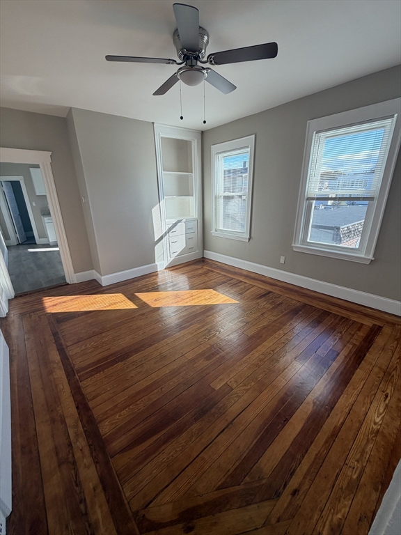 49 Federal Street, Unit 3 Beverly, MA 01915 - Photo 3 of 10 a view of an empty room with window and wooden floor