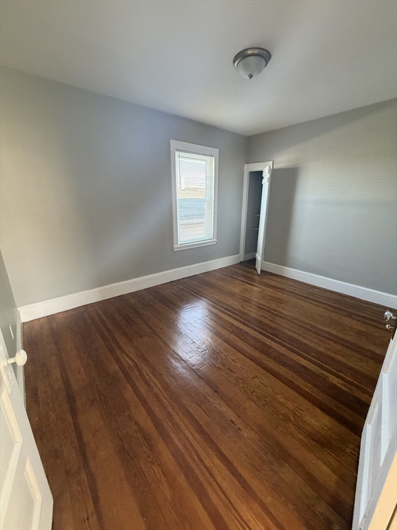 49 Federal Street, Unit 3 Beverly, MA 01915 - Photo 5 of 10 wooden floor in an empty room with a window