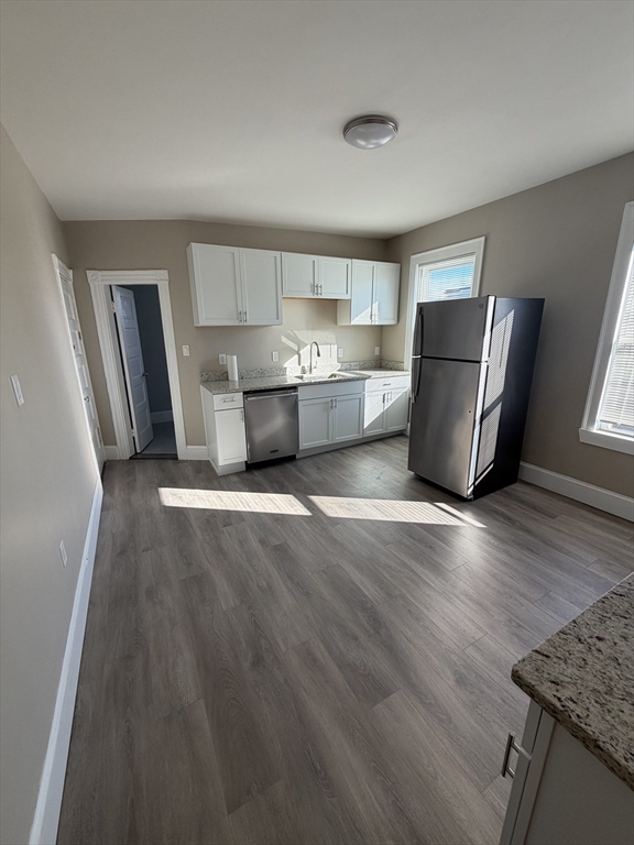 49 Federal Street, Unit 3 Beverly, MA 01915 - Photo 6 of 10 a living room with stainless steel appliances furniture and a kitchen view