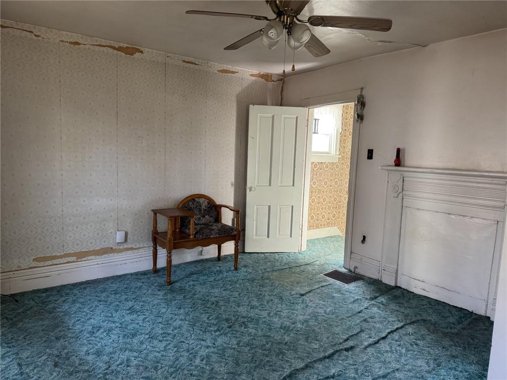 609 Lincoln Street Rochester, PA 15074 - Photo 11 of 24 a view of a livingroom with a chandelier fan and wooden floor