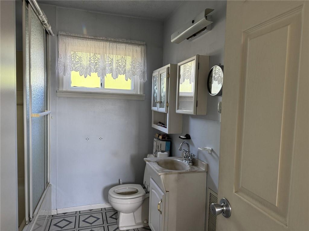609 Lincoln Street Rochester, PA 15074 - Photo 16 of 24 a bathroom with a toilet sink and mirror