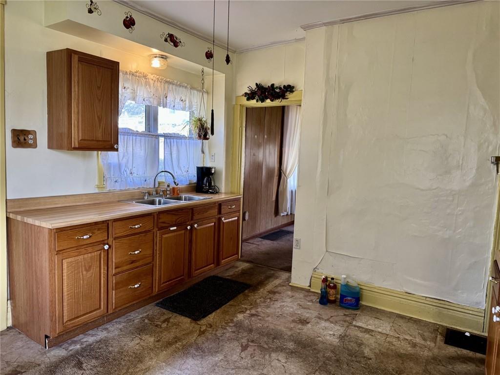 609 Lincoln Street Rochester, PA 15074 - Photo 5 of 24 a kitchen with sink refrigerator and cabinets