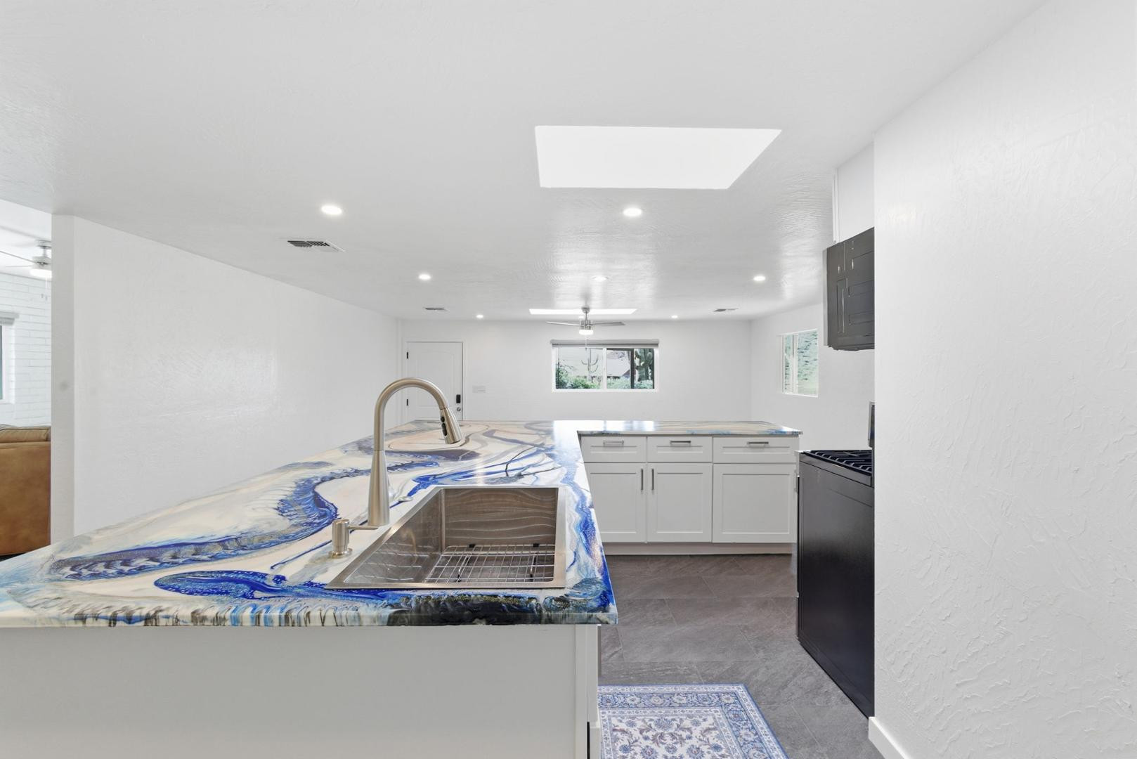 36975 North Sunset Trail Cave Creek, AZ 85331 - Photo 13 of 27 a kitchen with kitchen island granite countertop a sink stainless steel appliances and cabinets