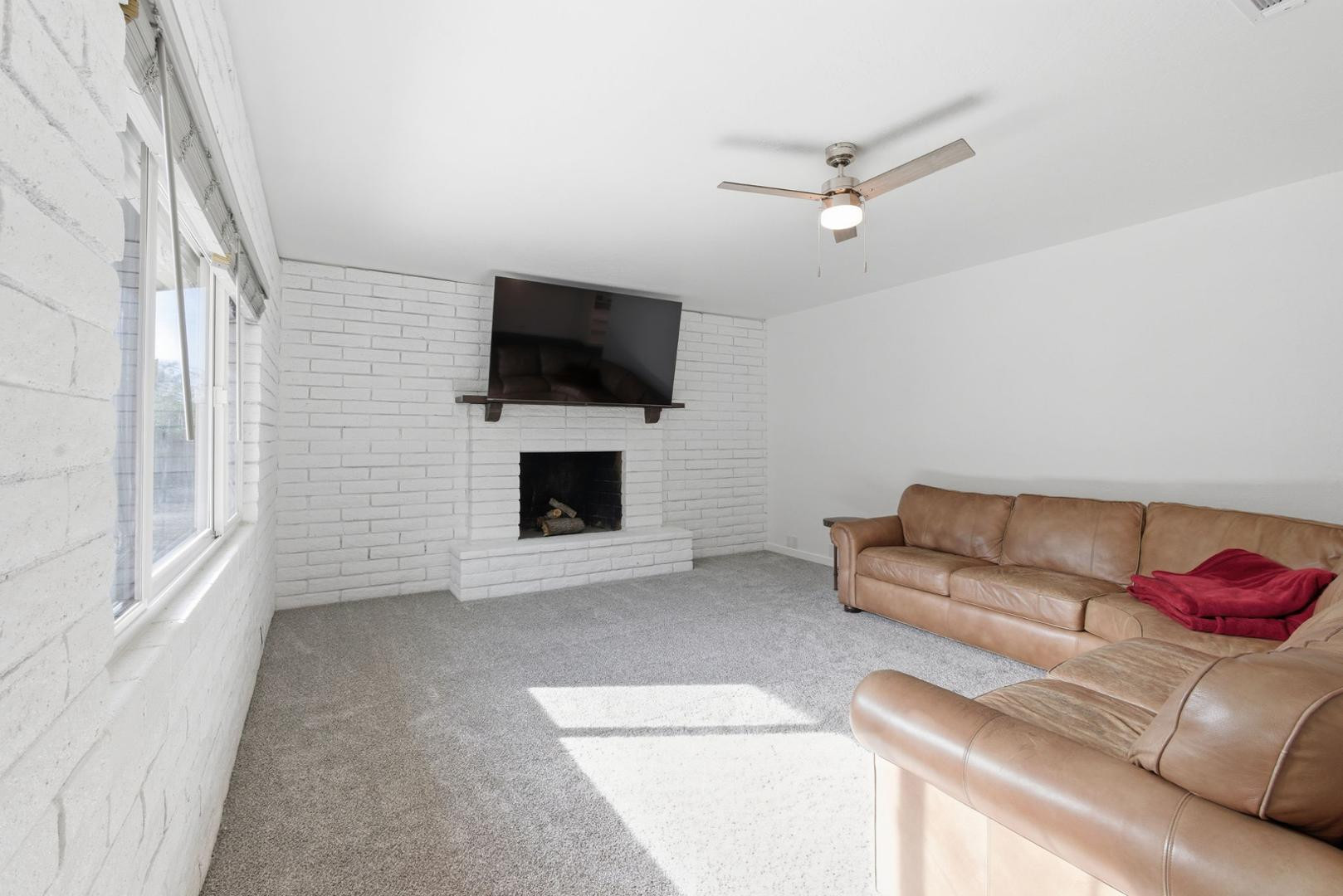 36975 North Sunset Trail Cave Creek, AZ 85331 - Photo 15 of 27 a living room with furniture and a flat screen tv