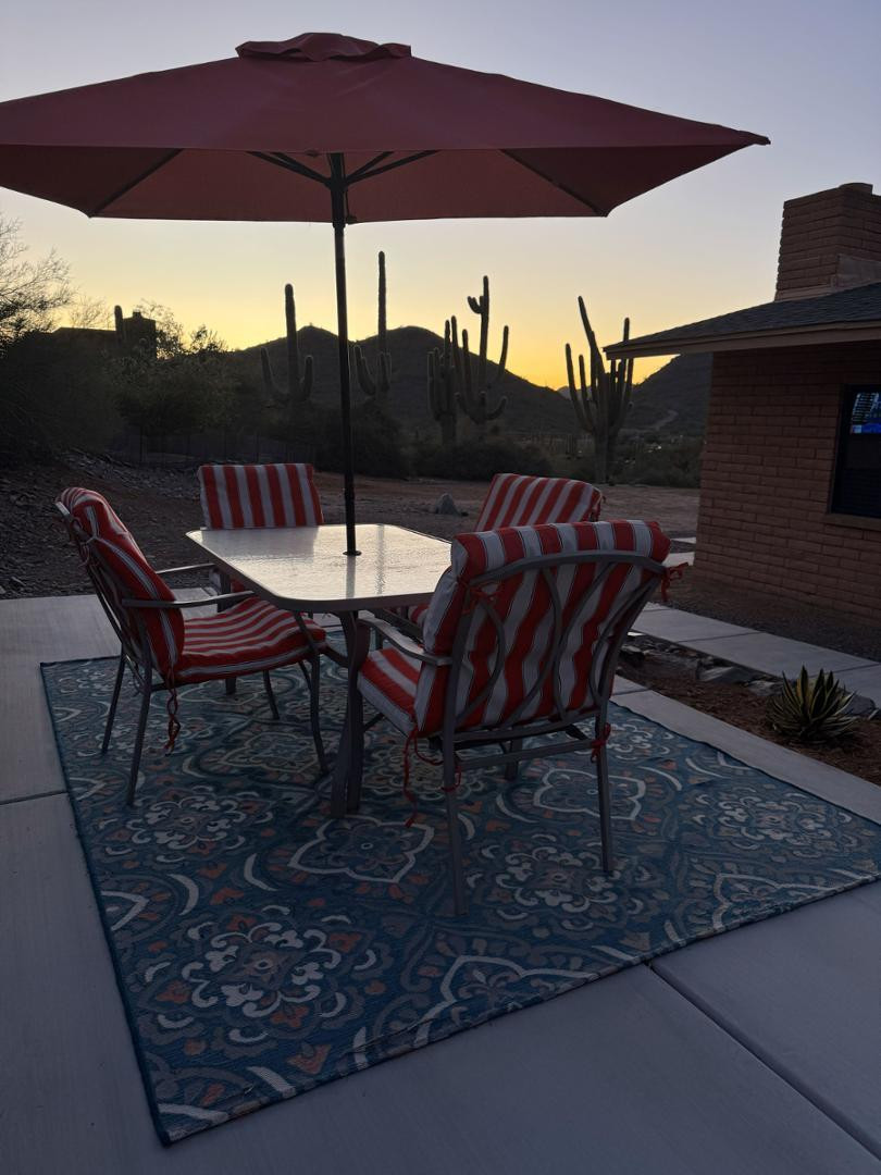 36975 North Sunset Trail Cave Creek, AZ 85331 - Photo 24 of 27 a view of a backyard with table and chairs under an umbrella