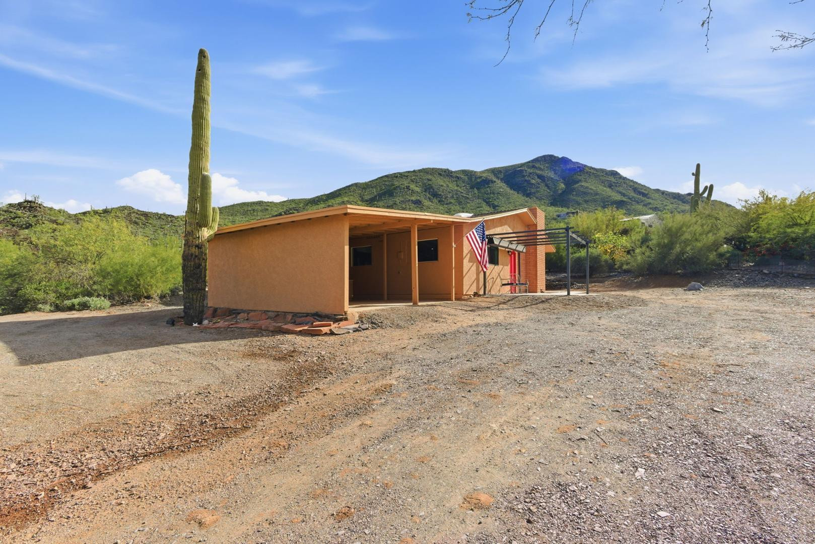 36975 North Sunset Trail Cave Creek, AZ 85331 - Photo 5 of 27 a front view of a house with a yard and garage