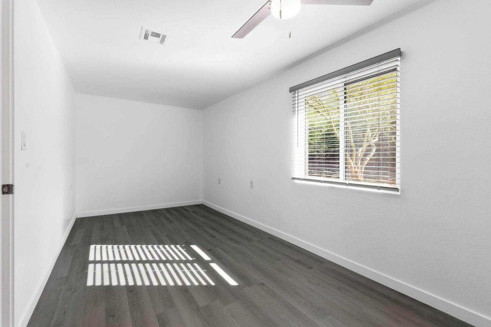 36975 North Sunset Trail Cave Creek, AZ 85331 - Photo 10 of 27 an empty room with wooden floor and windows