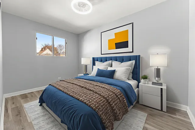 a bedroom with a bed and painting on the wall