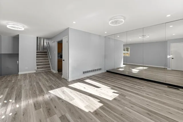 a view of a room with wooden floor