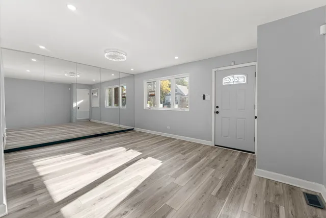 a view of a room with wooden floor and window