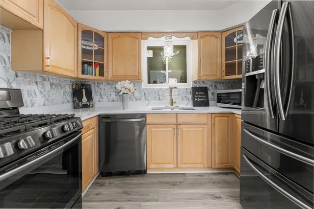 a kitchen with stainless steel appliances granite countertop a stove and a refrigerator