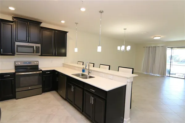 a kitchen with a sink cabinets and stainless steel appliances