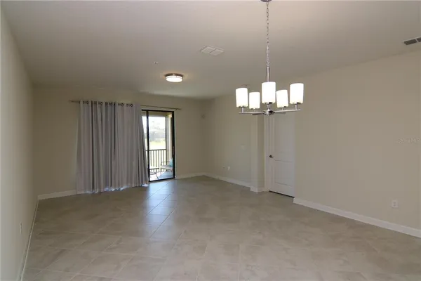 a view of a chandelier in big room and chandelier fan