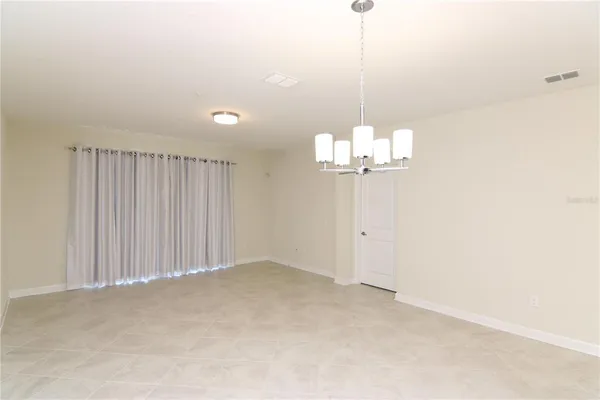 a view of a chandelier fan and fire place