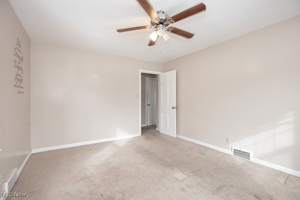 13545 Cedar Road Cleveland, OH 44118 - Photo 26 of 41 Empty room featuring light carpet, a ceiling fan, visible vents, and baseboards