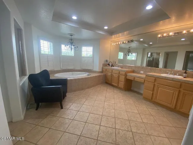 a large white kitchen with a large window