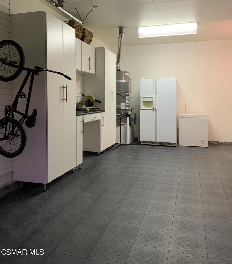 3082 Eaglewood Avenue Thousand Oaks, CA 91362 - Photo 24 of 29 a kitchen with cabinets and white appliances