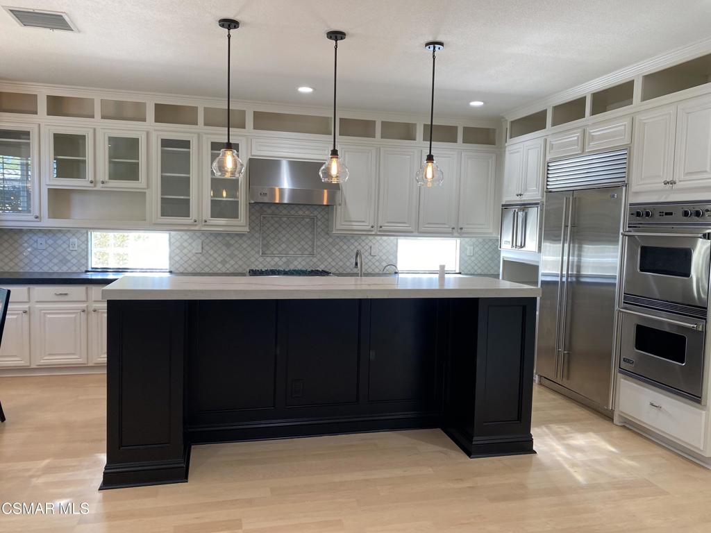 3082 Eaglewood Avenue Thousand Oaks, CA 91362 - Photo 4 of 29 a kitchen with kitchen island granite countertop wooden cabinets and stainless steel appliances