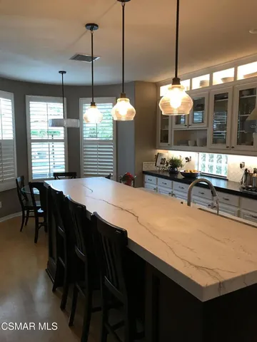 a kitchen with a table and chairs