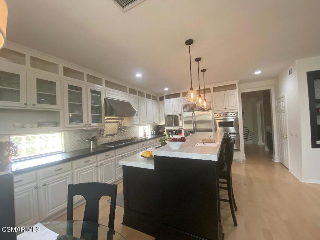 3082 Eaglewood Avenue Thousand Oaks, CA 91362 - Photo 6 of 29 a kitchen with stainless steel appliances kitchen island granite countertop a sink and cabinets