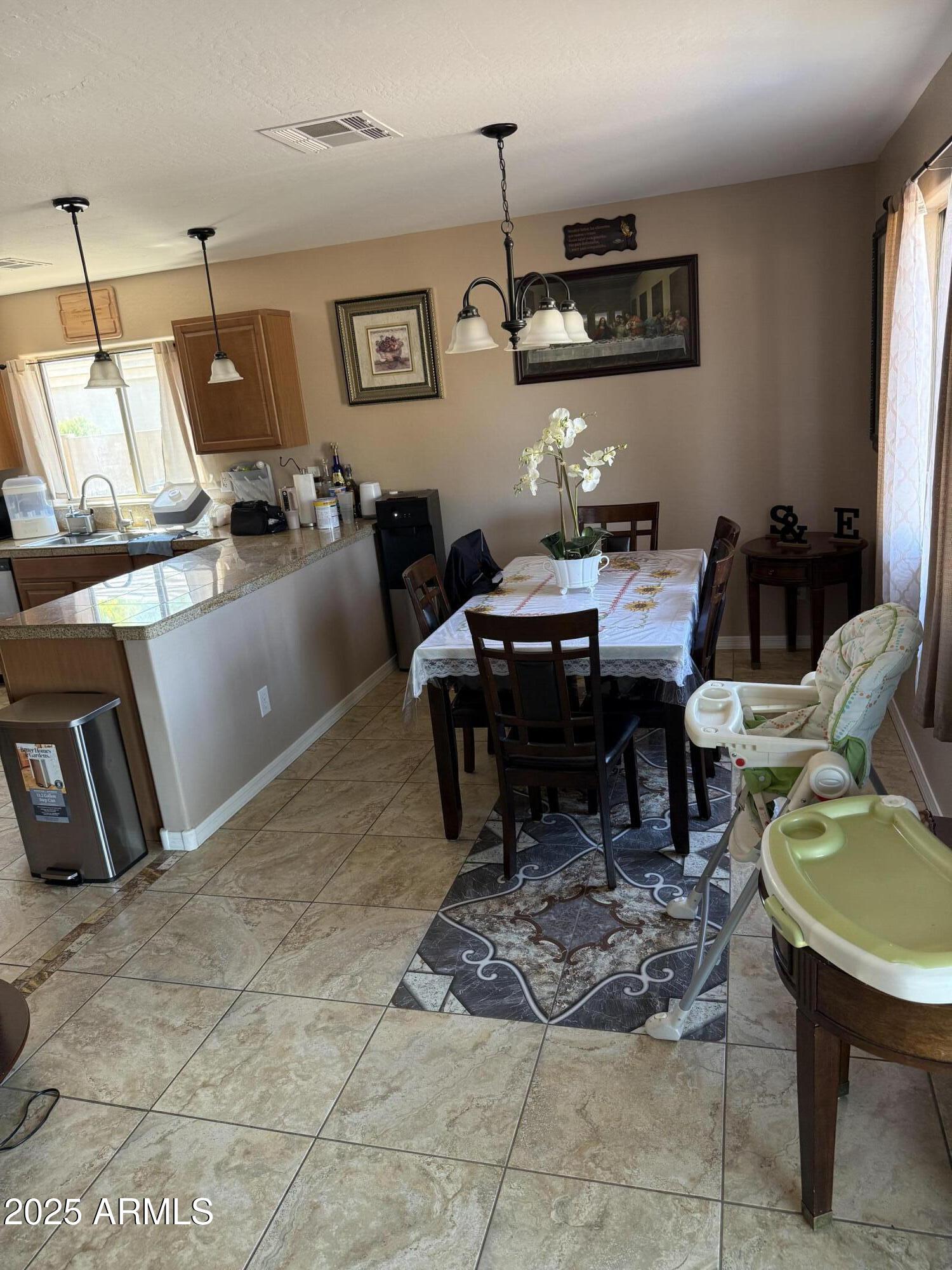 325 North 21st Circle Coolidge, AZ 85128 - Photo 4 of 6 a living room with lots of furniture and a chandelier