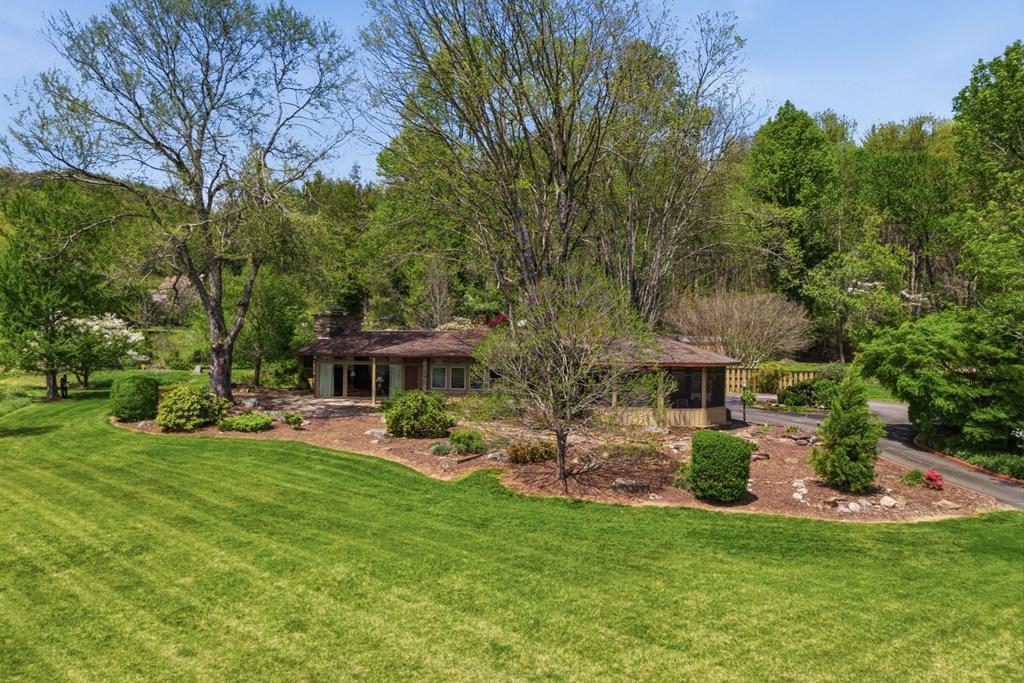 6203 Airport Road Andrews, NC 28901 - Photo 2 of 50 a view of a patio with table and chairs potted plants and large tree