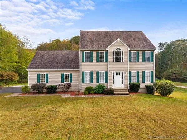 a front view of a house with a yard