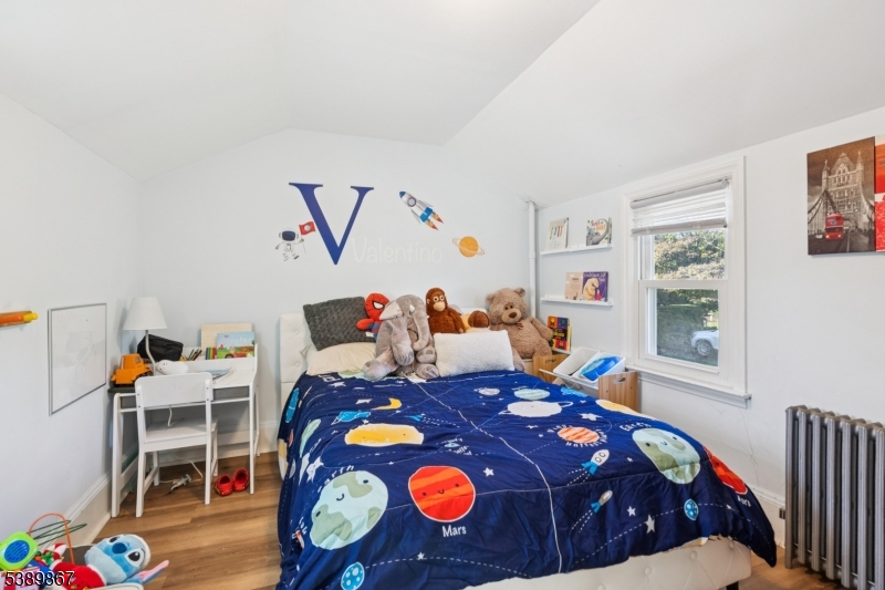 385 Ridge Road Dayton, NJ 08810 - Photo 14 of 14 a bed room with a bed and a table in it