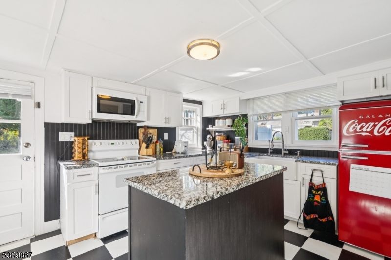 385 Ridge Road Dayton, NJ 08810 - Photo 5 of 14 a kitchen with kitchen island granite countertop a sink appliances cabinets and furniture