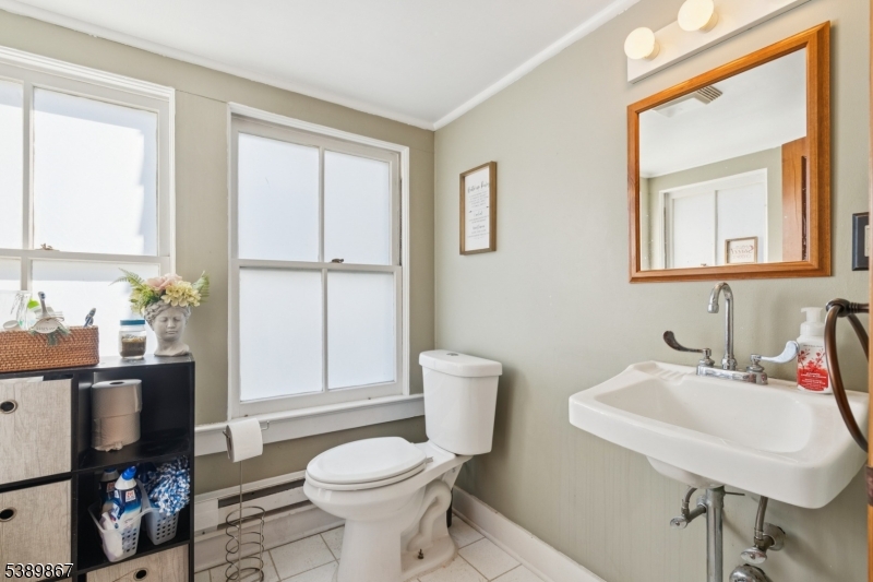 385 Ridge Road Dayton, NJ 08810 - Photo 9 of 14 a bathroom with a toilet a sink and a mirror