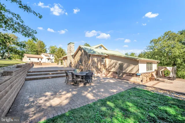 a view of a backyard with sitting area