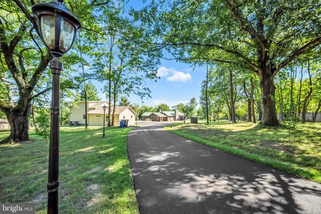 a view of an empty room with wooden floor and windows
