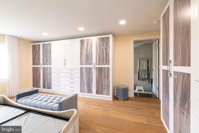 a living room with a bed furniture and a large window