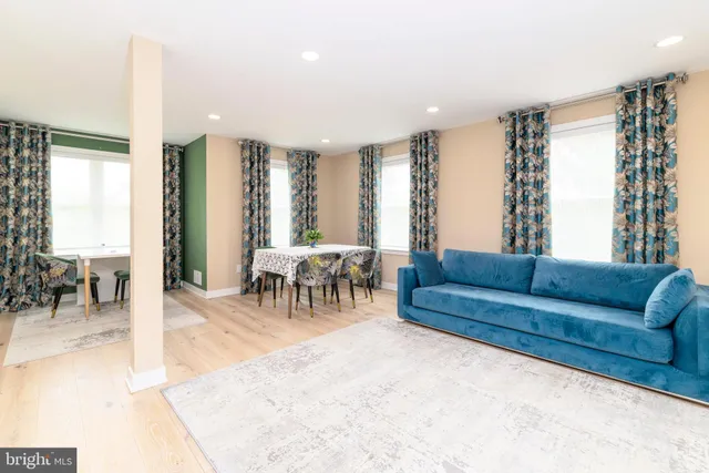 a living room with furniture and large windows