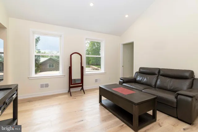 a view of staircase with railing and white walls