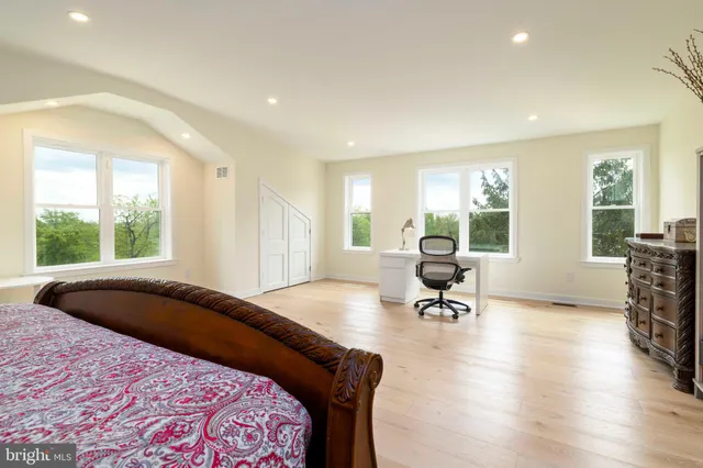 a bathroom with a sink vanity mirror and toilet