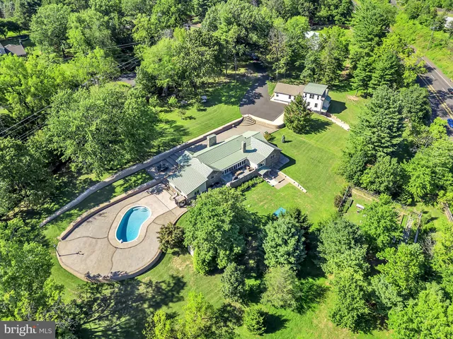 an aerial view of a house with swimming pool outdoor seating and yard
