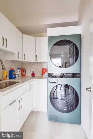 a bathroom with a granite countertop sink mirror and a bathtub