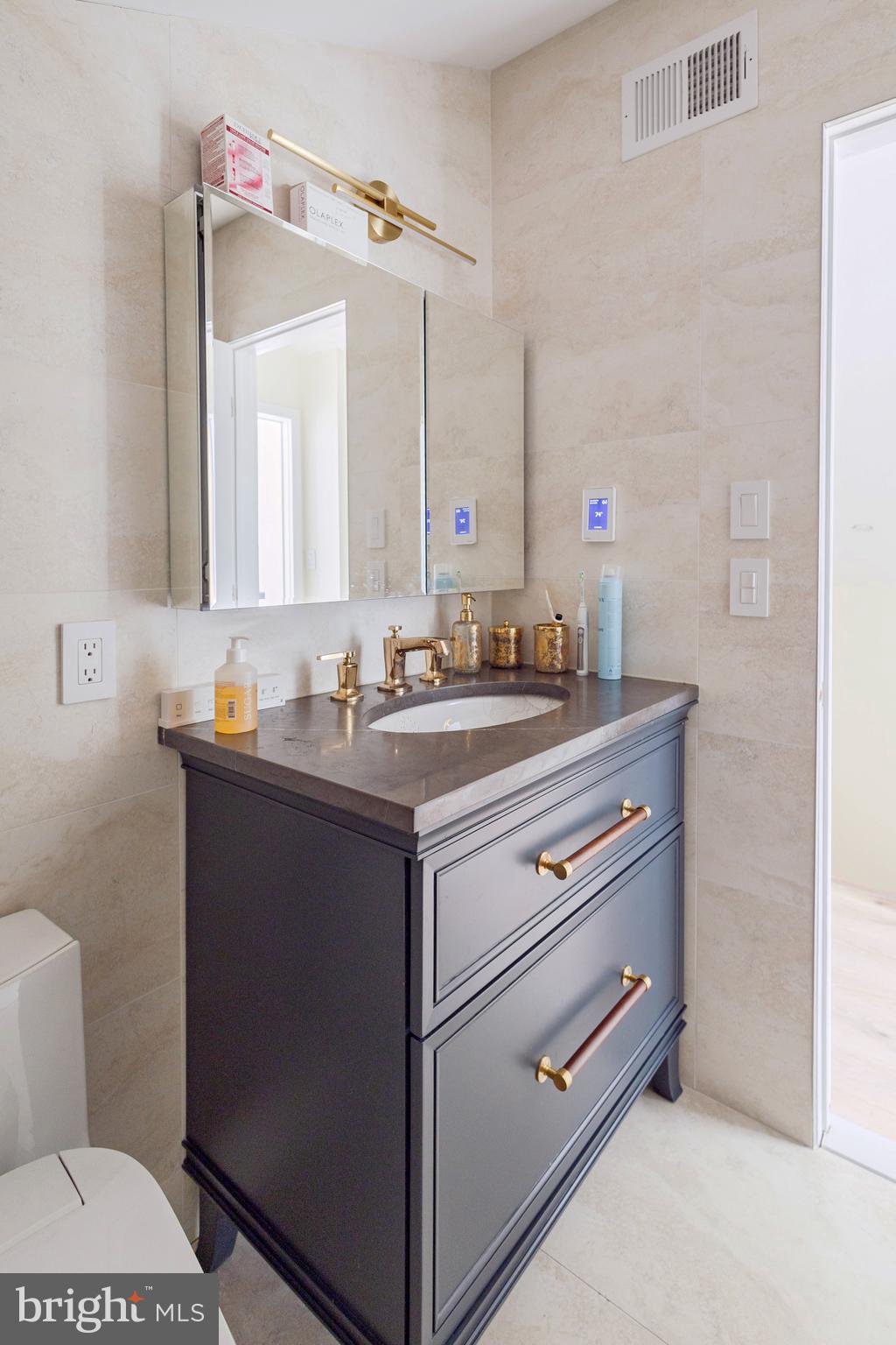 1851 Meetinghouse Road Warminster, PA 18974 - Photo 49 of 66 a bathroom with a sink vanity mirror and toilet