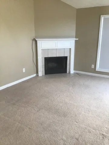 a view of empty room with a fireplace