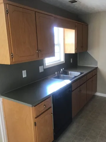 a kitchen with kitchen island granite countertop cabinets table and chairs