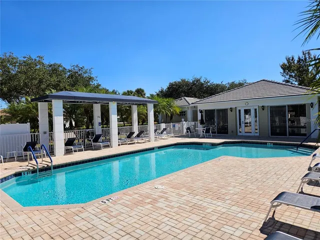 a view of a house with swimming pool and porch
