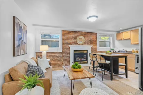 a living room with furniture dining table and a fireplace