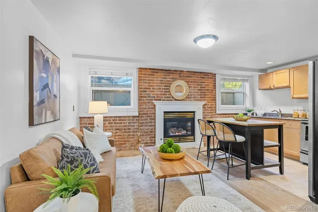 a living room with furniture dining table and a fireplace