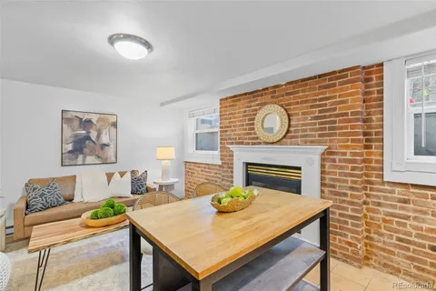 a view of a dining room with furniture and a fireplace