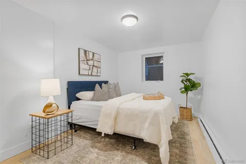 a bedroom with a bed and a potted plant