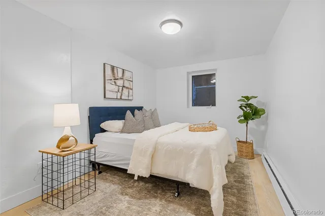 a bedroom with a bed and a potted plant